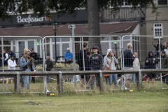 Members of the public watching the Derby from behind fencing that enclosed the racecourse from the public.Epsom 4-7-20.Photo © George Selwyn +44 (0)7967 030722116 Wellington Parade Kent UK CT14 8AF.
